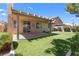 Inviting backyard features a covered patio and lush green lawn, perfect for outdoor relaxation and entertaining at 1132 Coral Desert Dr, Las Vegas, NV 89123