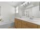 Bright bathroom with double sinks, soaking tub, and tiled floors at 1132 Coral Desert Dr, Las Vegas, NV 89123