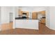 Open kitchen with wood cabinets and counter seating, seamlessly connected to the living spaces at 1132 Coral Desert Dr, Las Vegas, NV 89123