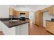 Well-lit kitchen featuring natural wood cabinets, an island, and tile flooring at 1132 Coral Desert Dr, Las Vegas, NV 89123
