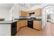 Functional kitchen with wooden cabinets, black appliances, and tile flooring at 1132 Coral Desert Dr, Las Vegas, NV 89123