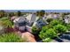 Aerial shot of the home with tile roof, a three car garage and surrounded by mature trees at 1266 Imperia Dr, Henderson, NV 89052