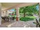 Serene backyard with covered patio, barbecue area, playground, and meticulously landscaped artificial turf at 1266 Imperia Dr, Henderson, NV 89052