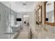 A bathroom with a soaking tub, glass shower, double vanity, and access to a bedroom at 1266 Imperia Dr, Henderson, NV 89052