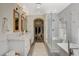 A bright bathroom with a soaking tub, glass shower, double vanity, and walk-in closet at 1266 Imperia Dr, Henderson, NV 89052