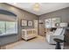 Modern Bedroom featuring a stylish crib, soft armchair, and window seat at 1266 Imperia Dr, Henderson, NV 89052