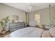 Well-lit bedroom showcasing a modern dresser and a hanging egg chair at 1266 Imperia Dr, Henderson, NV 89052