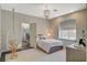 Bright bedroom featuring an egg chair, patterned wallpaper, and large walk-in closet at 1266 Imperia Dr, Henderson, NV 89052