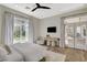 Inviting bedroom with an exterior balcony, a relaxing seating area, and a lush backyard view, creating a peaceful ambiance at 1266 Imperia Dr, Henderson, NV 89052