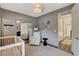 Neutral Bedroom with a crib, armchair, and mirrored closet reflecting the room at 1266 Imperia Dr, Henderson, NV 89052