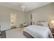 Comfortable bedroom with a decorative chandelier and a hanging egg chair near the closet at 1266 Imperia Dr, Henderson, NV 89052