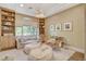 Beautiful bonus room with neutral colors, built-in bookshelves, and a cozy seating area for relaxation or recreation at 1266 Imperia Dr, Henderson, NV 89052