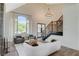 Elegant living room with tall windows, high ceilings, and a staircase at 1266 Imperia Dr, Henderson, NV 89052