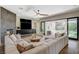 Cozy living room with plush sectional, backyard view, and sliding glass doors at 1266 Imperia Dr, Henderson, NV 89052