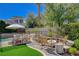 Relaxing backyard pool area with a built-in fire pit, lounge chairs, and mature landscaping at 1266 Imperia Dr, Henderson, NV 89052
