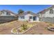 Low-maintenance backyard featuring rock landscaping, a fire pit, and a small patio area at 1320 Rainbow Meadows Dr, Las Vegas, NV 89128