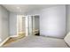 Neutral bedroom featuring a closet with mirrored doors and bright light at 1320 Rainbow Meadows Dr, Las Vegas, NV 89128