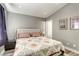 Cozy bedroom featuring a large bed, two side tables, and neutral grey walls at 1320 Rainbow Meadows Dr, Las Vegas, NV 89128