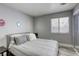 Cozy bedroom with a comfortable bed, gray walls, and ample natural light at 1320 Rainbow Meadows Dr, Las Vegas, NV 89128