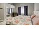 Bright bedroom featuring a plush bed, mirrored closet, and window with dark curtains at 1320 Rainbow Meadows Dr, Las Vegas, NV 89128