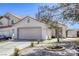 Charming single-story home with a two-car garage, xeriscape landscaping and mature shade tree at 1320 Rainbow Meadows Dr, Las Vegas, NV 89128
