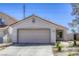 Charming single-story home with a two-car garage and low maintenance landscaping in a suburban neighborhood at 1320 Rainbow Meadows Dr, Las Vegas, NV 89128