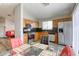 Eat-in kitchen equipped with stainless steel appliances, wood cabinets and dining area at 1320 Rainbow Meadows Dr, Las Vegas, NV 89128