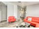 Bright living room with modern furniture, grey walls, sleek flooring, and an open floor plan at 1320 Rainbow Meadows Dr, Las Vegas, NV 89128