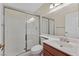 Bathroom featuring a shower with sliding glass doors, a vanity with sink, a toilet, and a large mirror at 1517 Kirby Dr, Las Vegas, NV 89117