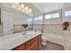 Well-lit bathroom featuring a vanity, bathtub, and tiled walls at 1517 Kirby Dr, Las Vegas, NV 89117