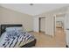 Bedroom with a bed, closet, neutral walls, and tile flooring, offering a serene and simple living space at 1517 Kirby Dr, Las Vegas, NV 89117