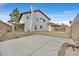 Rear exterior view of house showing backyard, concrete patio, and gate at 1517 Kirby Dr, Las Vegas, NV 89117