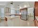 Modern kitchen with a central island, stainless steel refrigerator, and sleek countertops at 1517 Kirby Dr, Las Vegas, NV 89117