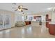 Bright living room featuring tile floors, ceiling fans, a comfortable couch, and a view of the kitchen area at 1517 Kirby Dr, Las Vegas, NV 89117