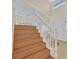 Well-lit staircase with wooden steps, leading to the upper floors of the home, and a view of the front entry at 1517 Kirby Dr, Las Vegas, NV 89117