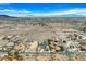 Wide angle aerial view displaying the neighborhood with mountain views in the distance at 156 N Parawan St, Henderson, NV 89015