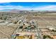 Expansive aerial view of a desert community with distant mountains and scattered homesites at 156 N Parawan St, Henderson, NV 89015