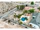 The backyard features a large yard with a sparkling pool, a putting green, and mature palm trees offering a peaceful retreat at 156 N Parawan St, Henderson, NV 89015