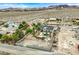 A lush backyard featuring a sparkling pool, a small putting green, and mature palm trees for a serene retreat at 156 N Parawan St, Henderson, NV 89015
