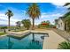 Resort-style backyard with a sparkling pool, built-in bar, and desert landscaping at 156 N Parawan St, Henderson, NV 89015