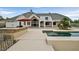 Expansive backyard features an inviting pool, outdoor kitchen, and white exterior elevation at 156 N Parawan St, Henderson, NV 89015