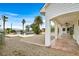 A covered patio extends into a backyard with pool, desert landscaping, and city views at 156 N Parawan St, Henderson, NV 89015