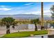 Backyard showing putting green, city views, lush desert landscaping at 156 N Parawan St, Henderson, NV 89015