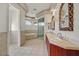 This bathroom features tile flooring, a long vanity with double sinks, a glass shower and a tub at 156 N Parawan St, Henderson, NV 89015