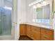 This bathroom features a glass enclosed shower with tiled walls, and vanity with drawers at 156 N Parawan St, Henderson, NV 89015