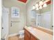 Bathroom with neutral wall color, vanity with sink, toilet, and bathtub-shower with window at 156 N Parawan St, Henderson, NV 89015