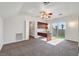 Spacious bedroom with a ceiling fan, built in desk, and sliding glass doors to the outside at 156 N Parawan St, Henderson, NV 89015
