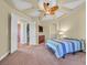This is a primary bedroom showcasing a custom ceiling and fan, and an ensuite bathroom at 156 N Parawan St, Henderson, NV 89015
