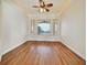Serene bedroom with hardwood floors, tray ceiling, and a large window offering beautiful views, a peaceful retreat at 156 N Parawan St, Henderson, NV 89015