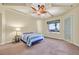 Bedroom with ceiling fan, a door to the exterior, and a striped comforter at 156 N Parawan St, Henderson, NV 89015